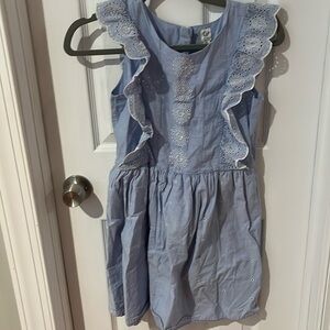 Blue dress with little holes and ruffles down the sleeve with zipper in the back
